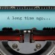 Vintage Typewriter With Phrase "A long time ago..." Typed in Blue Paper